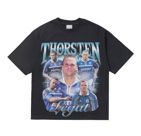 Black T-shirt with a graphic print of a male figure with the name 'THORSTEN' and the word 'LEGAT' below it, surrounded by additional images of the same person in different poses and expressions.