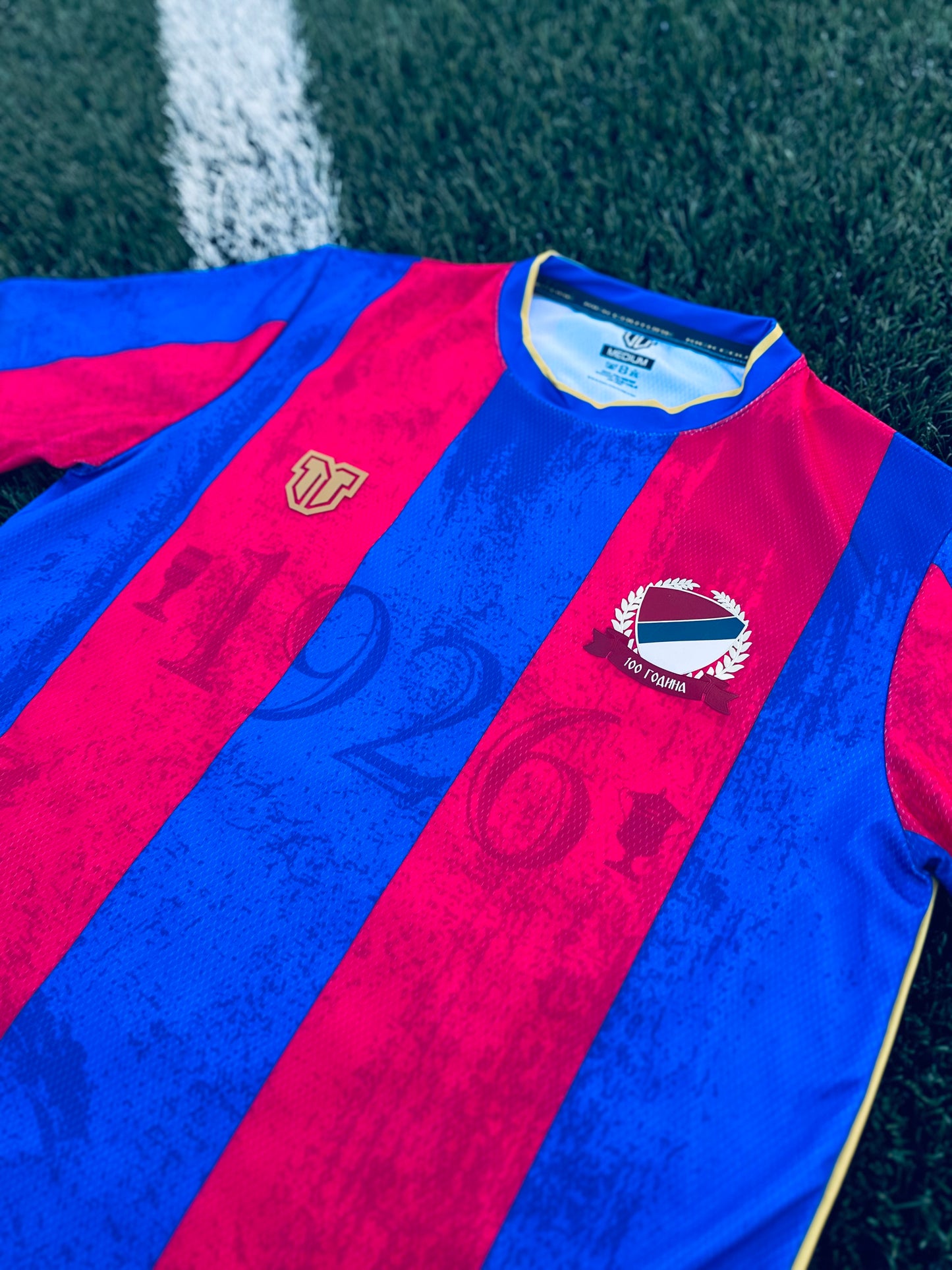 Close-up of a Borac Banja Luka concept red and blue sports jersey with logos and text.